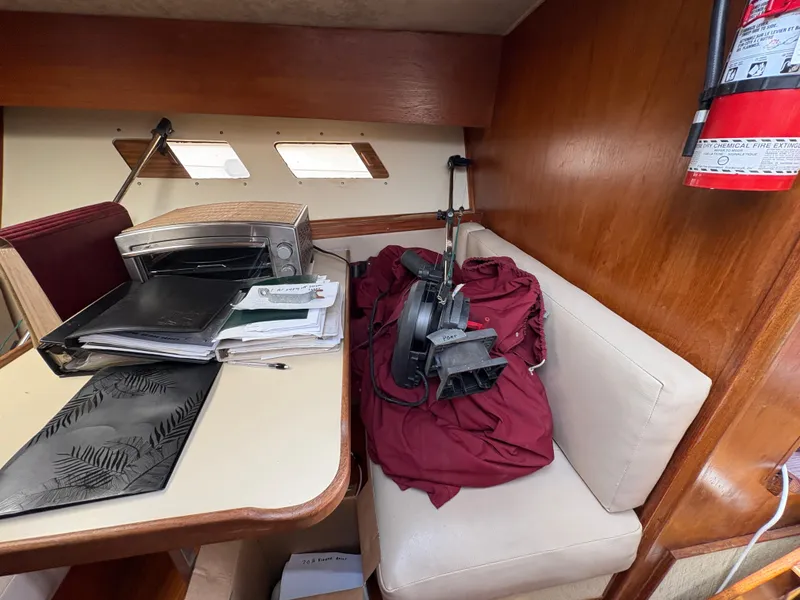 Slide: The Image of Interior of 1986 Trojan 32 Sedan with table, documents, and equipment. - 33