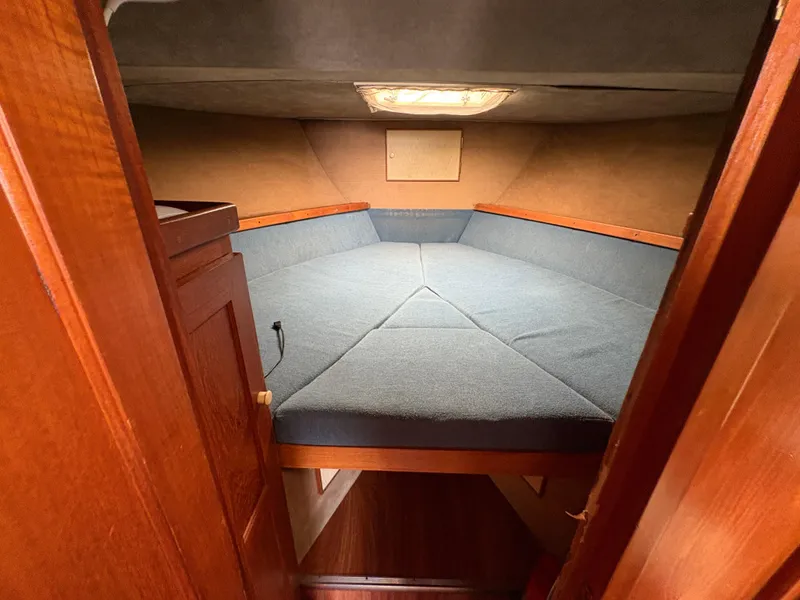 Slide: The Image of 1986 Trojan 32 Sedan cabin interior with blue upholstery and wooden accents. - 36