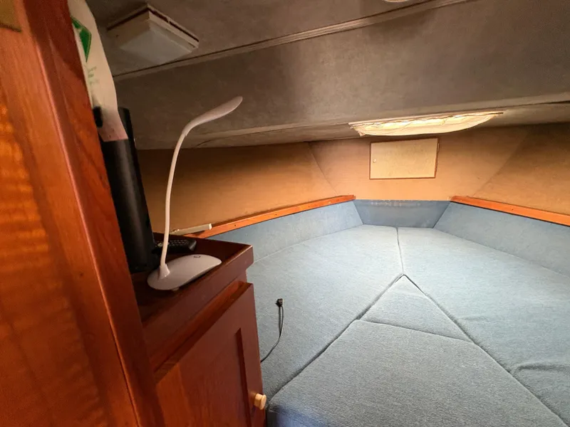 Slide: The Image of Interior cabin of a 1986 Trojan 32 Sedan with blue upholstery and wooden accents. - 38