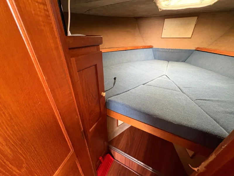 Slide: The Image of 1986 Trojan 32 Sedan interior cabin with blue cushions and wooden accents. - 39