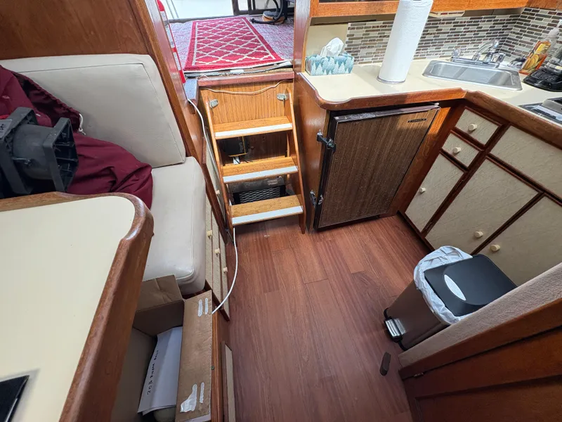 Slide: The Image of Interior of a 1986 Trojan 32 Sedan boat with kitchen and seating area. - 40