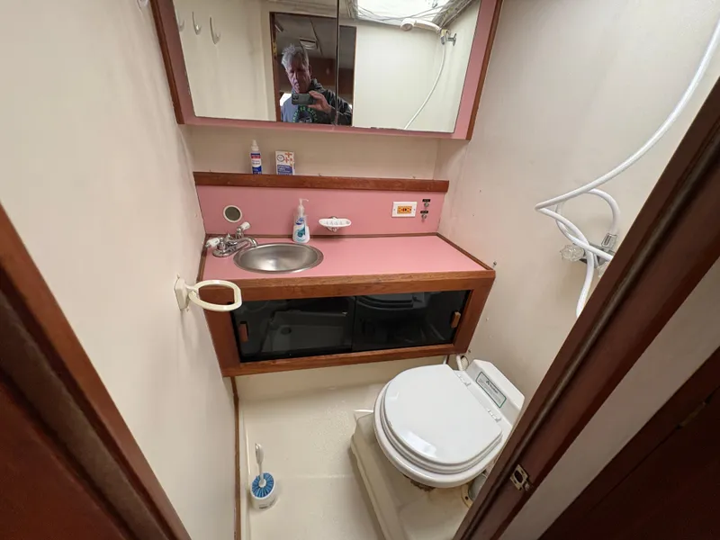 Slide: The Image of 1986 Trojan 32 Sedan bathroom with sink, toilet, and mirror. - 45