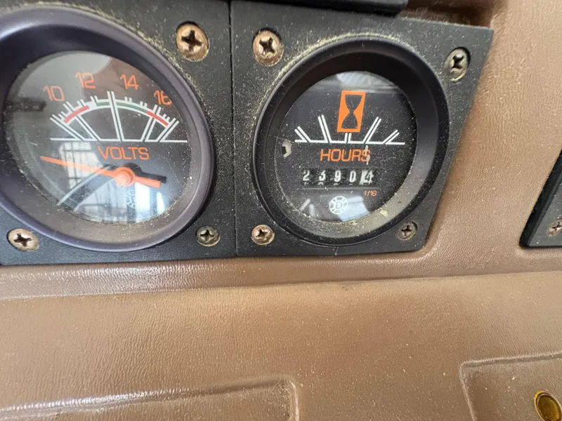 Slide: The Image of Close-up of 1986 Trojan 32 Sedan dashboard gauges showing volts and engine hours. - 50