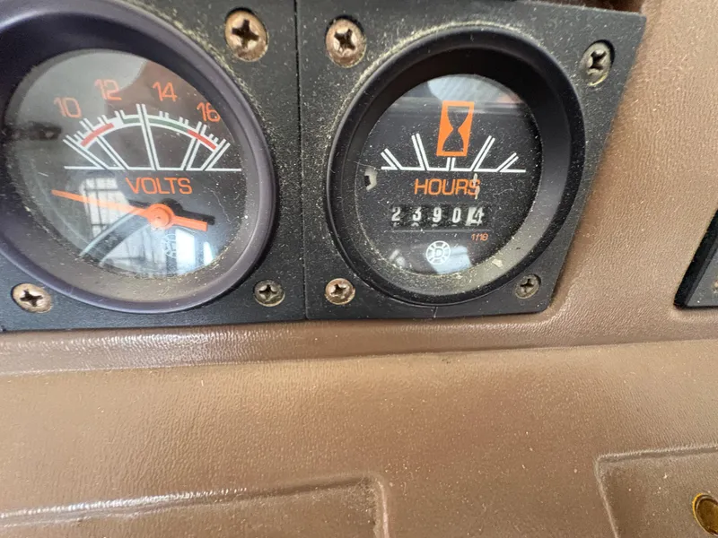 Slide: The Image of 1986 Trojan 32 Sedan dashboard showing voltmeter and hour meter readings. - 51