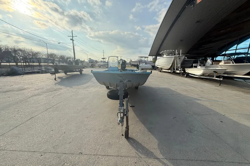 Slide: The Image of 1990 Duracraft 1860 DC boat on trailer in marina storage area. - 14