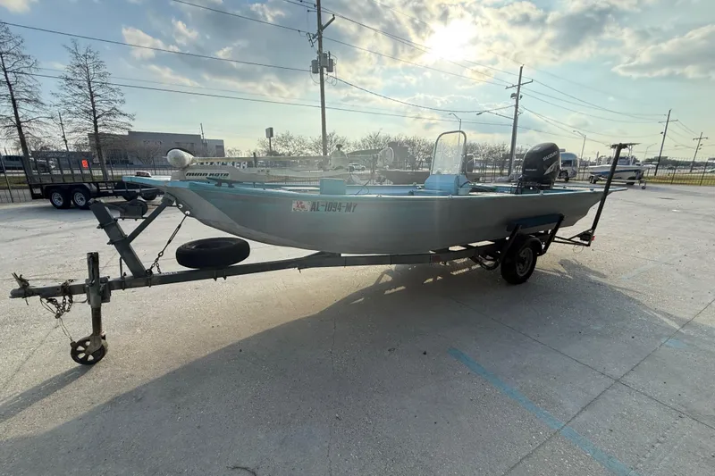 Slide: The Image of 1990 Duracraft 1860 DC boat on trailer in sunny parking lot. - 5