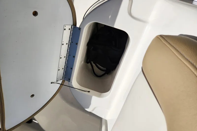 Slide: The Image of Storage compartment in 2020 Key West 203 FS boat with beige seating. - 12