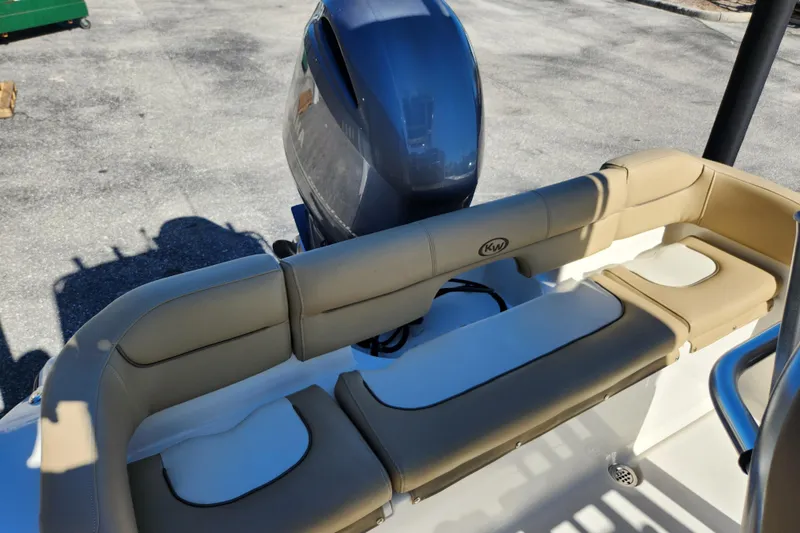 Slide: The Image of 2020 Key West 203 FS boat with tan seating and outboard motor. - 15