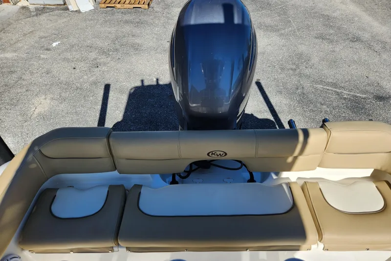 Slide: The Image of 2020 Key West 203 FS boat with beige seating and outboard motor. - 16