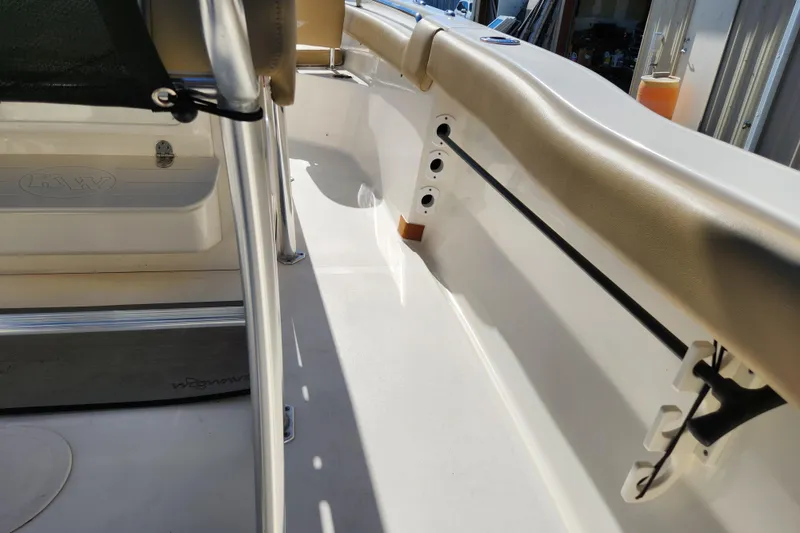 Slide: The Image of 2020 Key West 203 FS boat interior with beige seating and storage compartments. - 20