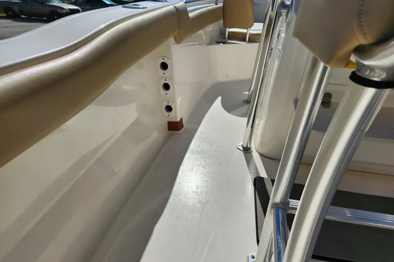 Slide: The Image of 2020 Key West 203 FS boat interior with beige seating and stainless steel fixtures. - 21