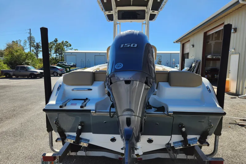 Slide: The Image of 2020 Key West 203 FS boat with 150 HP engine, parked outdoors. - 4