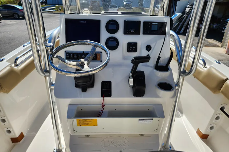 Slide: The Image of 2020 Key West 203 FS boat console with steering wheel and navigation controls. - 7