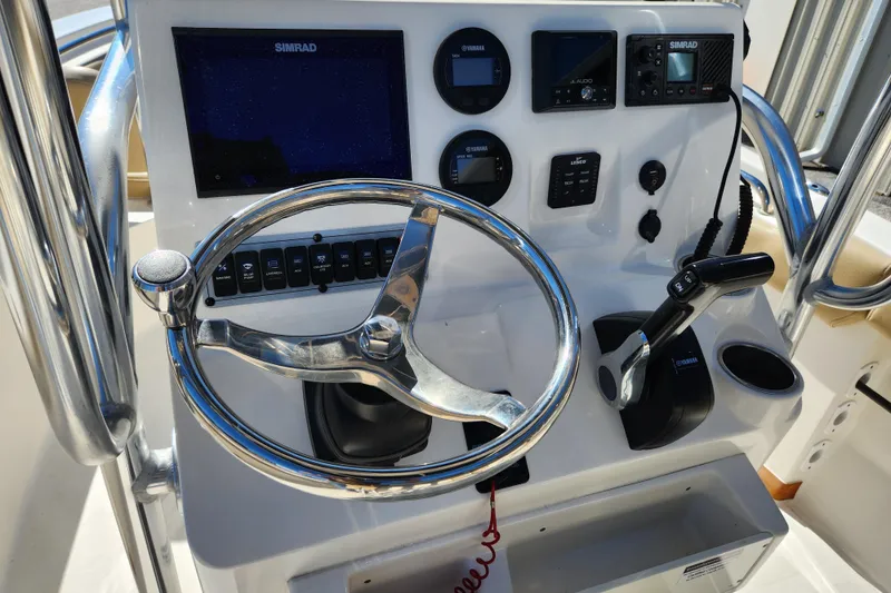 Slide: The Image of 2020 Key West 203 FS boat dashboard with steering wheel and control panel. - 8