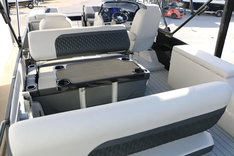 Slide: The Image of 2026 Sylvan L3 DLZ boat interior with seating and table, showcasing modern design. - 11
