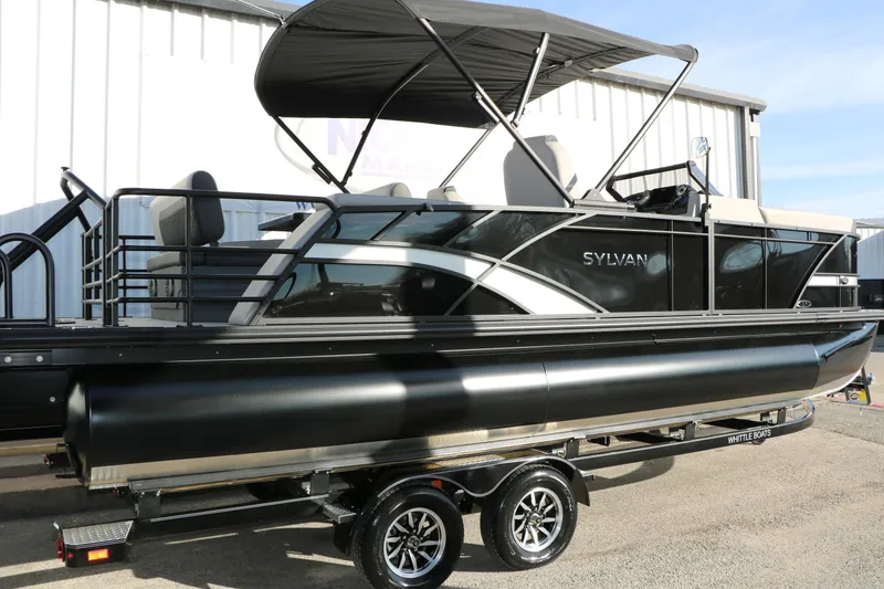 Slide: The Image of 2026 Sylvan L3 DLZ pontoon boat with sleek design and canopy on trailer. - 2