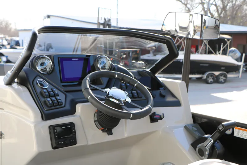 Slide: The Image of 2026 Sylvan L3 DLZ boat dashboard with steering wheel and navigation display. - 22