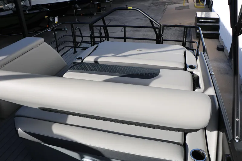 Slide: The Image of 2026 Sylvan L3 DLZ pontoon boat interior with cushioned seating and cup holders. - 30