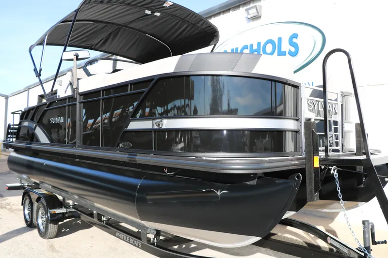 Slide: The Image of 2026 Sylvan L3 DLZ pontoon boat with sleek black design on trailer. - 4