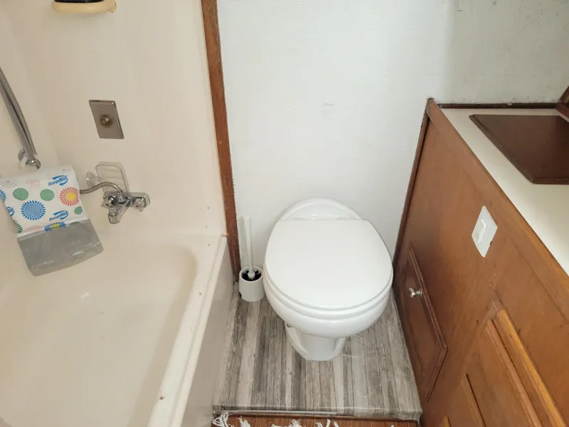 Slide: The Image of 1974 Californian 42 LRC boat bathroom with toilet, sink, and shower area. - 11