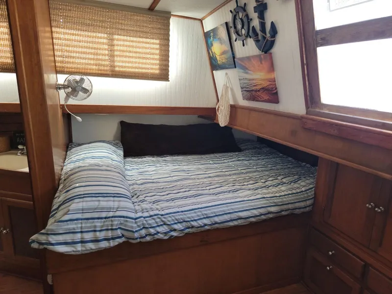 Slide: The Image of Cozy cabin bedroom in 1974 Californian 42 LRC boat with nautical decor. - 13
