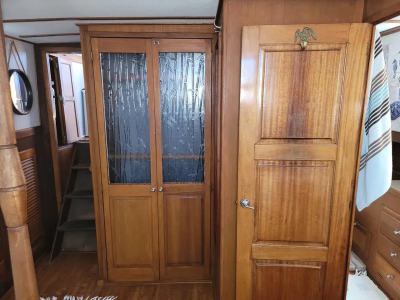 Slide: The Image of Interior of 1974 Californian 42 LRC yacht with wooden cabinetry and stairs. - 15