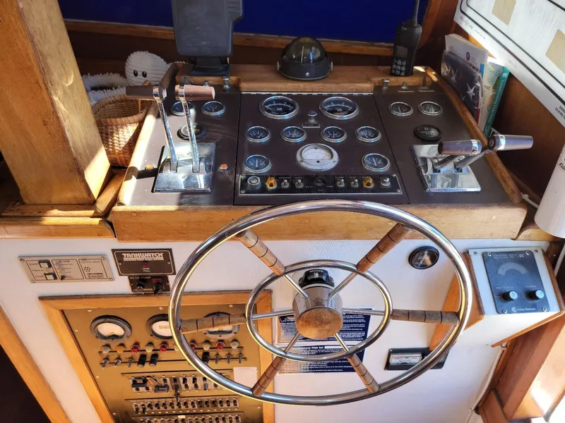 Slide: The Image of 1974 Californian 42 LRC boat helm with gauges, controls, and steering wheel. - 16
