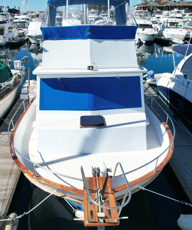 Slide: The Image of 1974 Californian 42 LRC yacht docked at a marina, surrounded by other boats. - 18