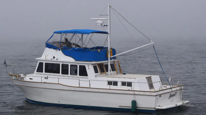 Slide: The Image of 1974 Californian 42 LRC yacht with blue canopy on foggy water. - 21
