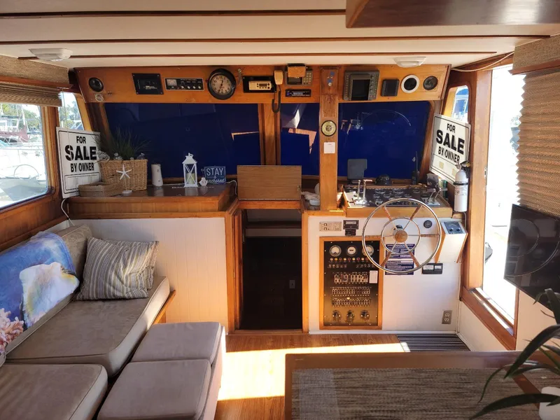 Slide: The Image of 1974 Californian 42 LRC yacht interior with helm, seating, and "For Sale" signs. - 3