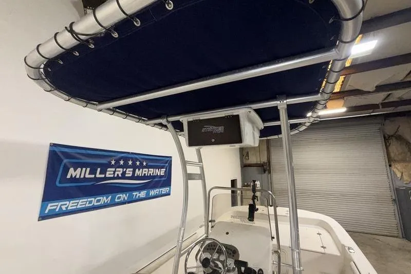 Slide: The Image of 2020 Carolina Skiff 21 LS boat with T-top, displayed at Miller's Marine showroom. - 11