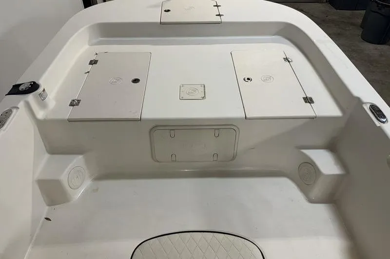 Slide: The Image of 2020 Carolina Skiff 21 LS boat interior with storage compartments and seating area. - 19