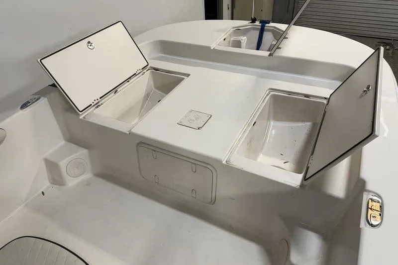 Slide: The Image of 2020 Carolina Skiff 21 LS boat with open storage compartments on deck. - 20