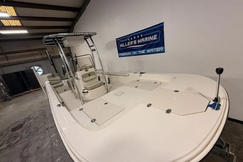 Slide: The Image of 2020 Carolina Skiff 21 LS boat in showroom, featuring spacious deck and seating. - 3
