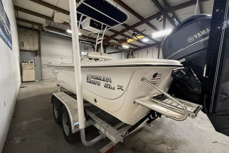 Slide: The Image of 2020 Carolina Skiff 21 LS boat on trailer in a garage with Yamaha engine. - 5