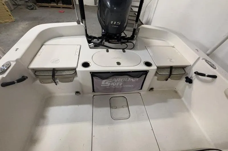 Slide: The Image of 2020 Carolina Skiff 21 LS boat interior with Yamaha 115 engine in a garage. - 7