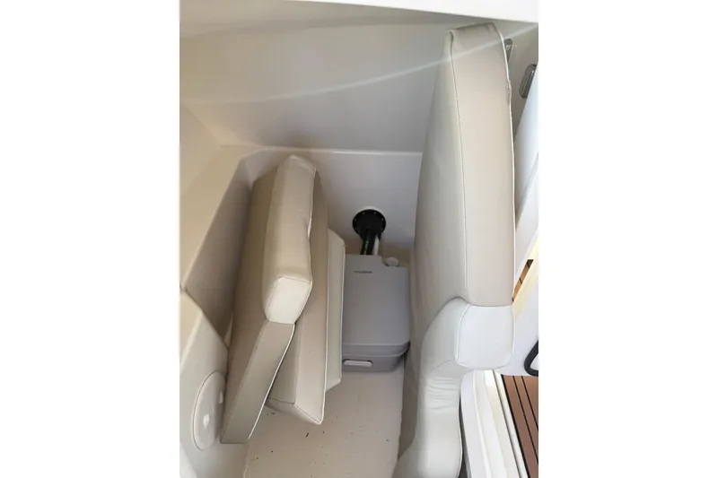 Slide: The Image of Interior of 2022 Boston Whaler 240 Vantage boat, featuring compact seating and storage area. - 3