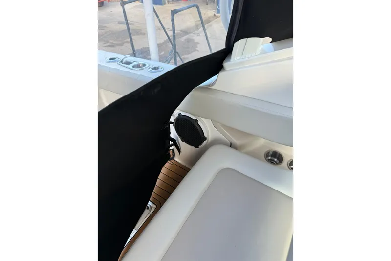 Slide: The Image of Interior view of a 2022 Boston Whaler 240 Vantage boat, featuring seating and cup holders. - 4