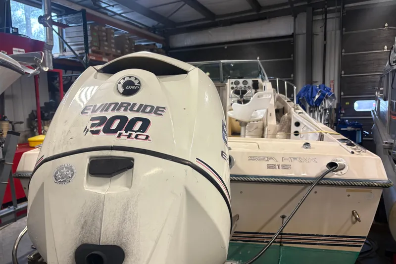 Slide: The Image of 1987 Sea Hawk 215 boat with Evinrude 200 H.O. engine in a garage. - 5