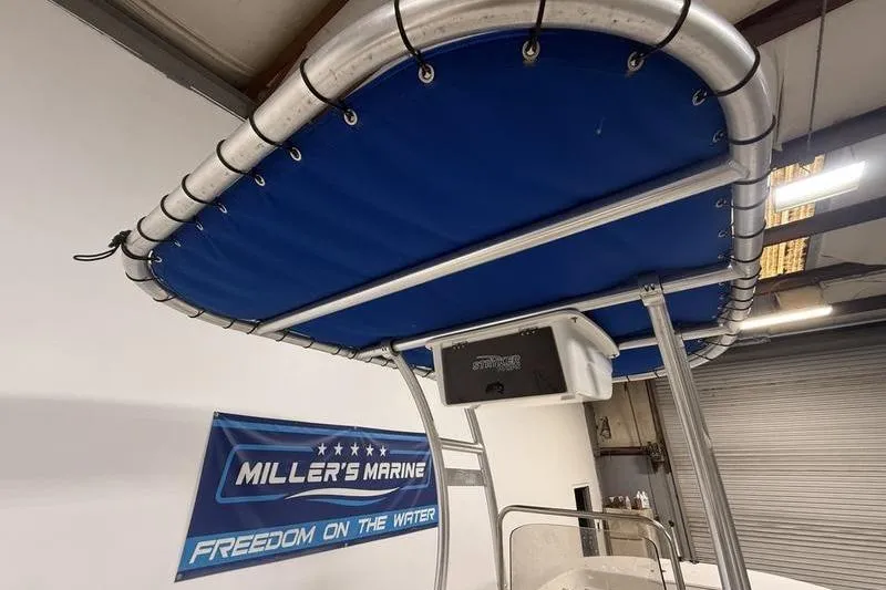Slide: The Image of 2020 Carolina Skiff 21 LS boat with blue canopy at Miller's Marine showroom. - 16