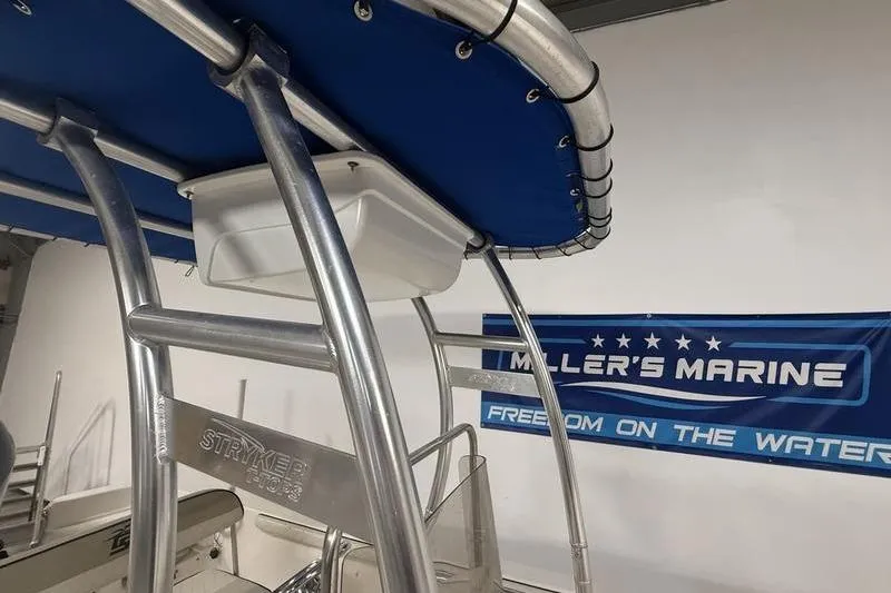 Slide: The Image of 2020 Carolina Skiff 21 LS boat with blue canopy at Miller's Marine showroom. - 17