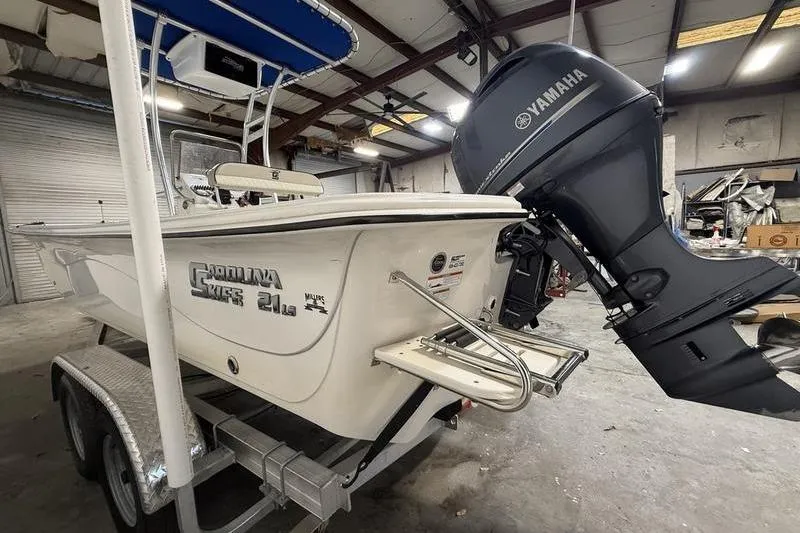 Slide: The Image of 2020 Carolina Skiff 21 LS boat with Yamaha outboard motor in a garage. - 6