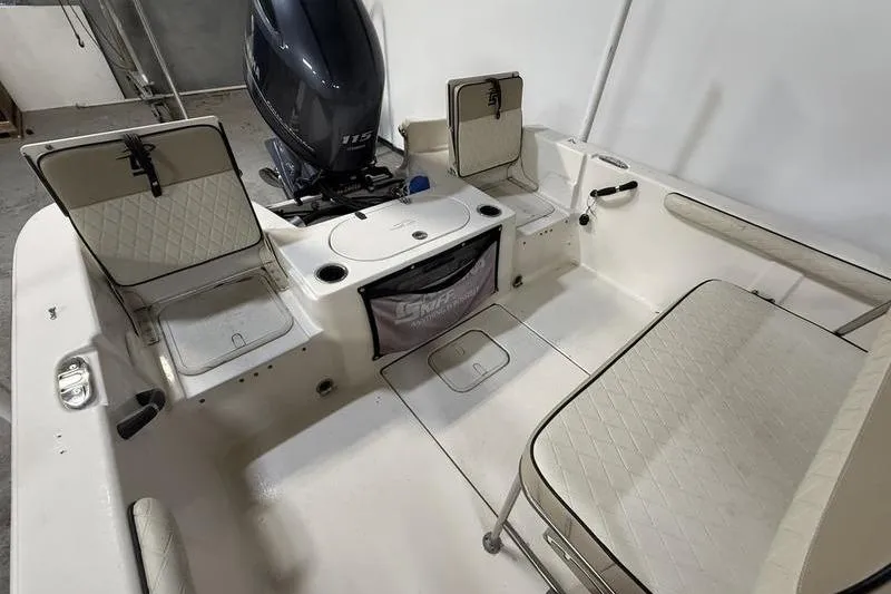 Slide: The Image of 2020 Carolina Skiff 21 LS boat interior with seating and storage compartments. - 8