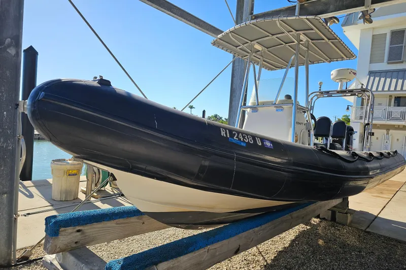 The Image of 2007 Ribcraft 6.5 boat on a lift, dockside, under clear blue sky. - 1