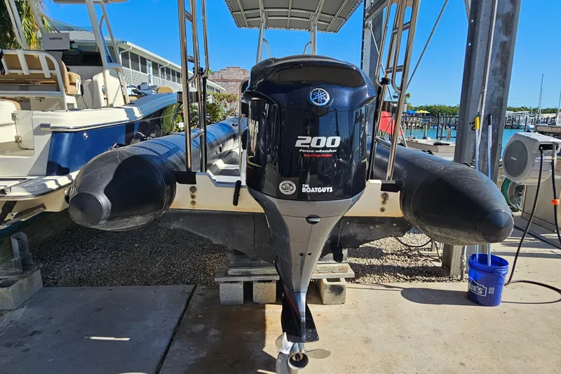 Slide: The Image of 2007 Ribcraft 6.5 boat with Yamaha 200 engine on a dock. - 10