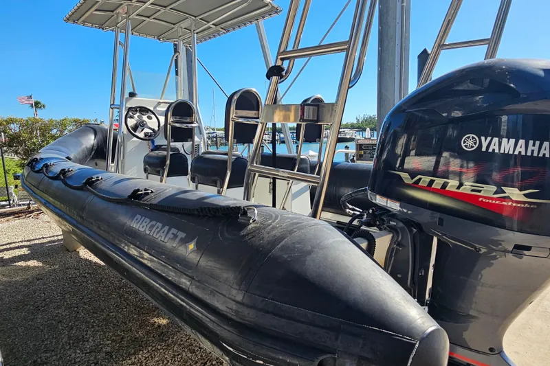 Slide: The Image of 2007 Ribcraft 6.5 boat with Yamaha VMAX engine, docked under clear blue sky. - 11