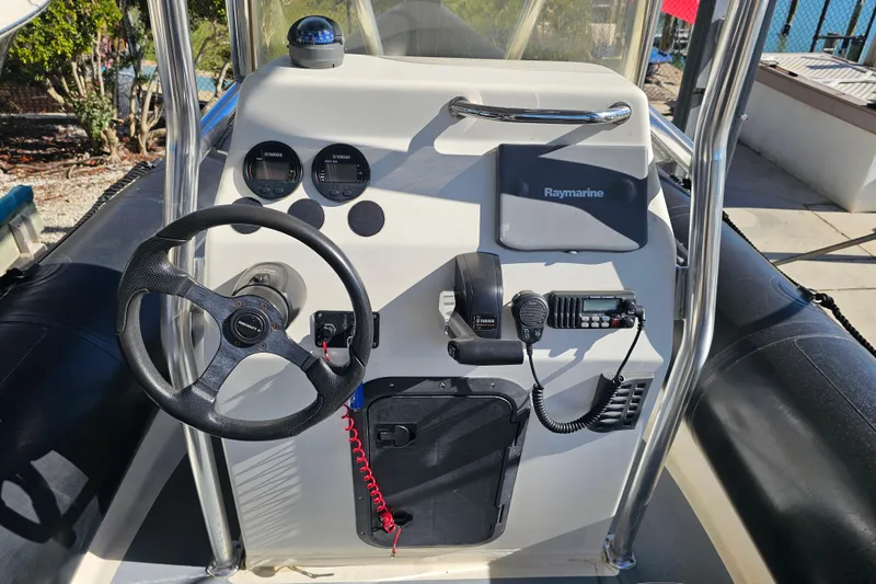 Slide: The Image of 2007 Ribcraft 6.5 boat console with steering wheel, Yamaha controls, and Raymarine equipment. - 18
