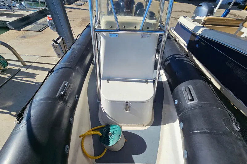 Slide: The Image of 2007 Ribcraft 6.5 boat interior with console and inflatable tubes at dock. - 22