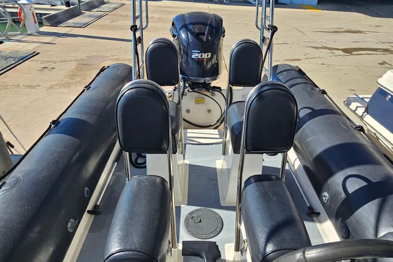 Slide: The Image of 2007 Ribcraft 6.5 boat interior with Yamaha 200 engine, docked at marina. - 23