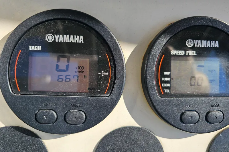 Slide: The Image of Yamaha tachometer and speed fuel gauges on a 2007 Ribcraft 6.5 boat dashboard. - 26